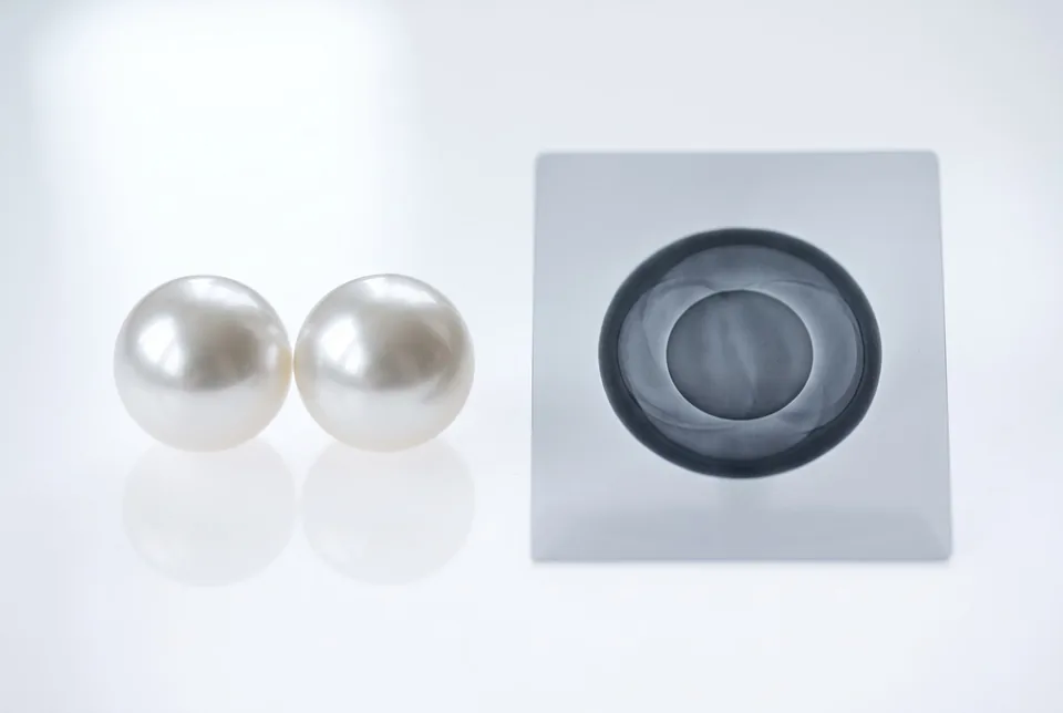 Two pearls on a lightbox with an X-ray silhouette